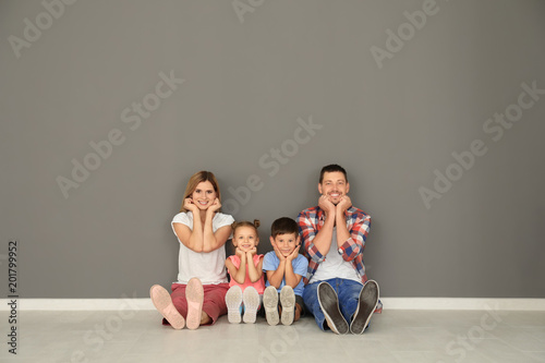 Happy family sitting on flo...