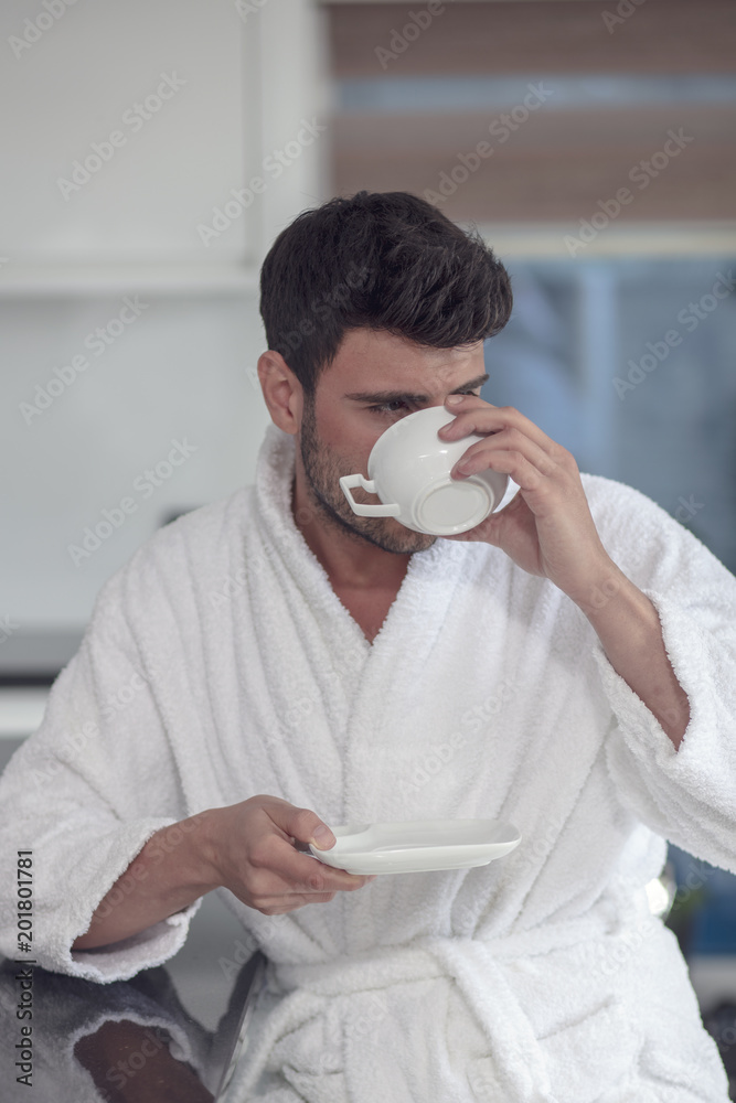 Morning portrait of handsome young man with cup of coffee Morning portrait of handsome young man with cup of coffee