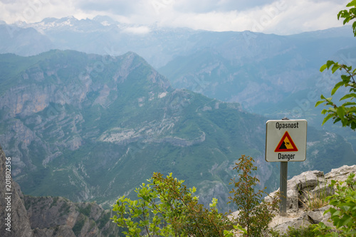 At the top of the mountain there is a sign warning of the danger of falling from a height.