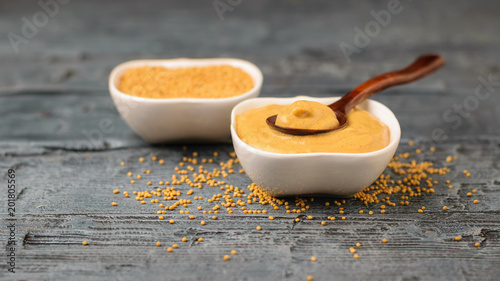 Freshly made mustard sauce on a wooden table.