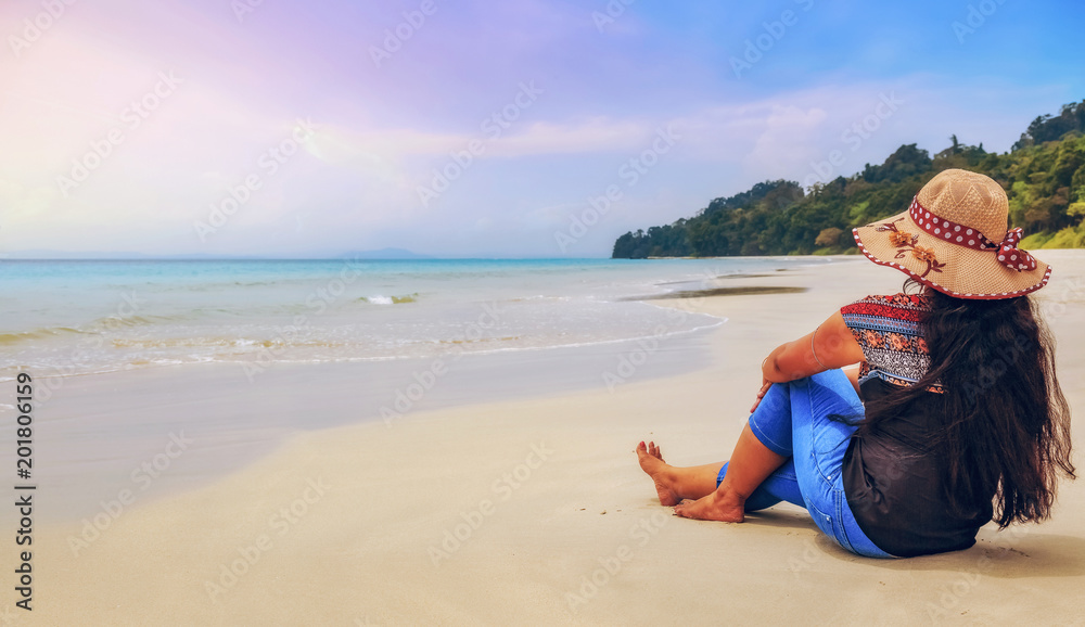 Young female tourist enjoy sunset at Havelock Island beach Andaman, India.