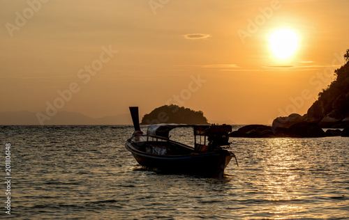 Early morning sunrise over the sea and a fishing boat