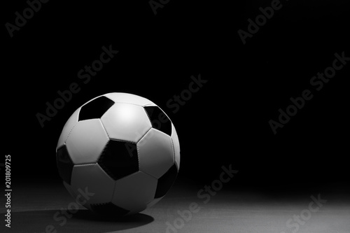 Soccer ball on the black background