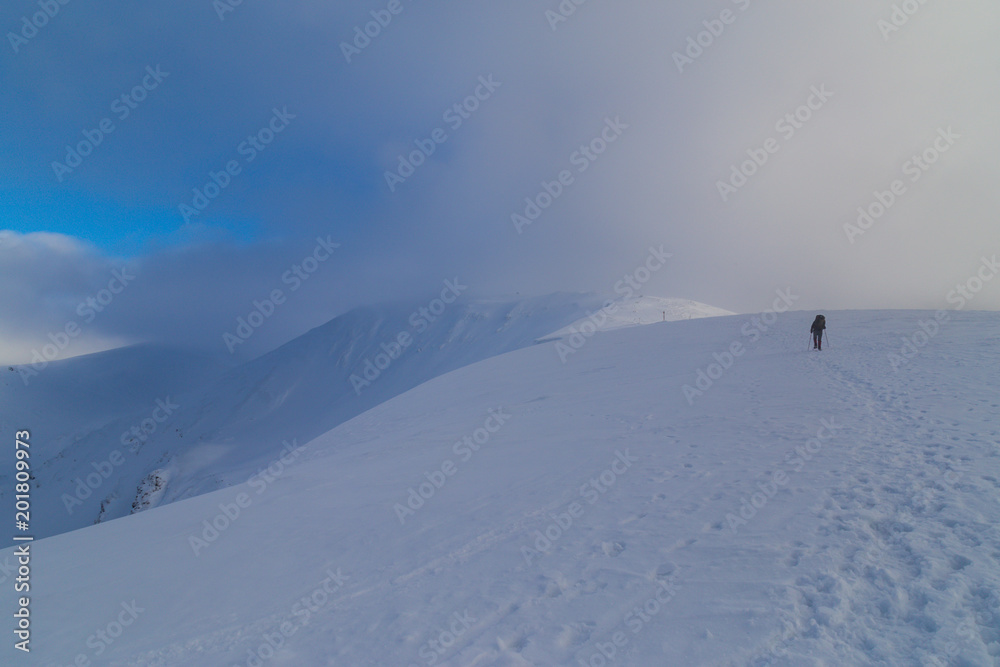Beautiful winter scenery in the mountains, with fresh snow, and mist, on a bright sunny day
