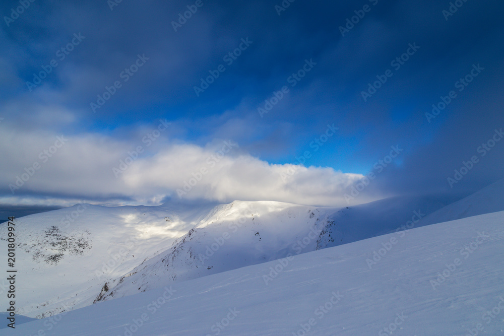 Beautiful  winter scenery in the mountains, with fresh snow, and mist, on a bright sunny day