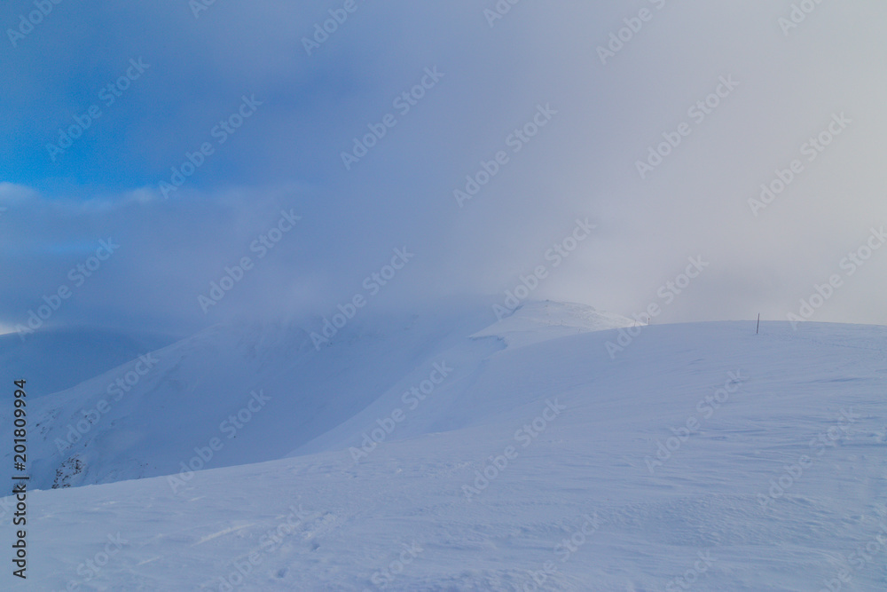 Beautiful winter scenery in the mountains, with fresh snow, and mist, on a bright sunny day Beautiful winter scenery in the mountains, with fresh snow, and mist, on a bright sunny day