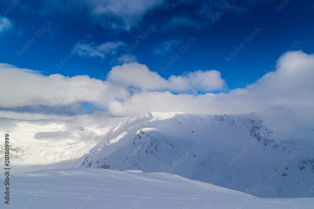 Beautiful  winter scenery in the mountains, with fresh snow, and mist, on a bright sunny day