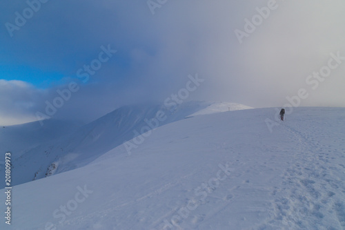 Beautiful winter scenery in the mountains, with fresh snow, and mist, on a bright sunny day