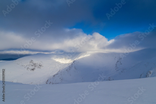 Beautiful winter scenery in the mountains, with fresh snow, and mist, on a bright sunny day