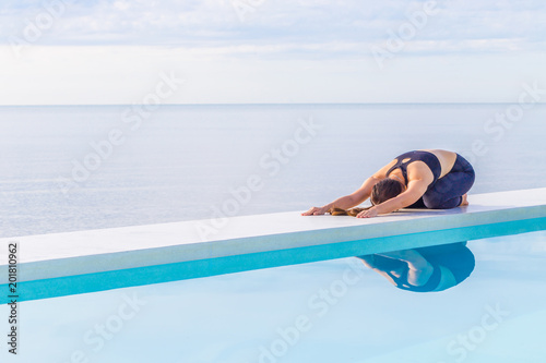 Asian woman practice yoga Child's Pose on the beach in the morning,Feeling so comfortable and relax in holiday,Healthy Concept