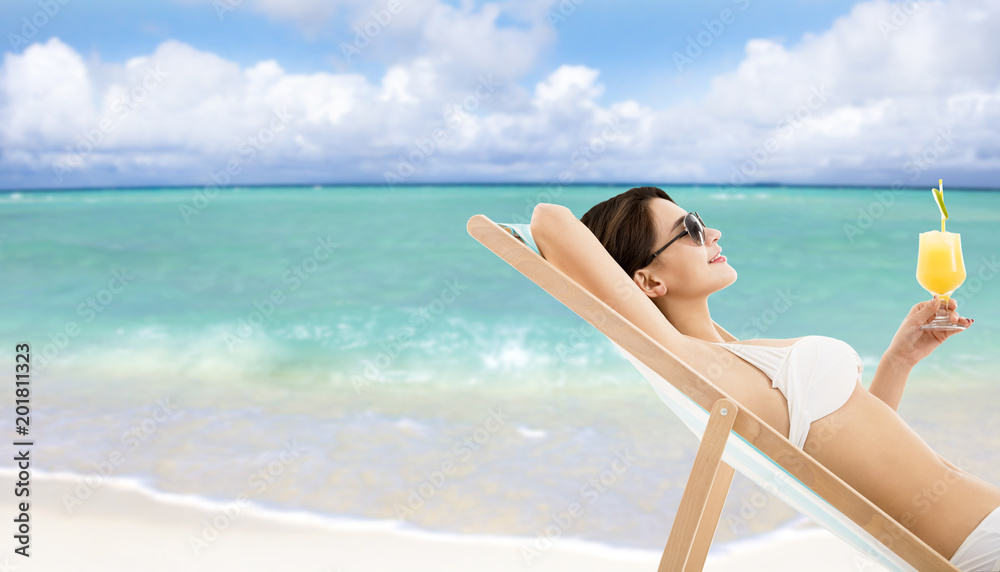 relaxed woman in lounge chair with cocktail relaxed woman in lounge chair with cocktail