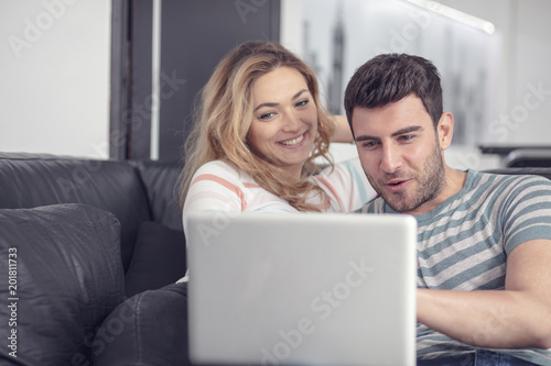 Joyful husband and wife relaxing at home