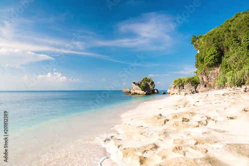 Fototapeta Naklejka Na Ścianę i Meble -  Tropical sand beach with rocks and blue ocean in Bali