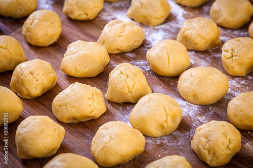 Wallpaper Mural A close-up of the process of cooking buns or pancakes on a wooden table Torontodigital.ca