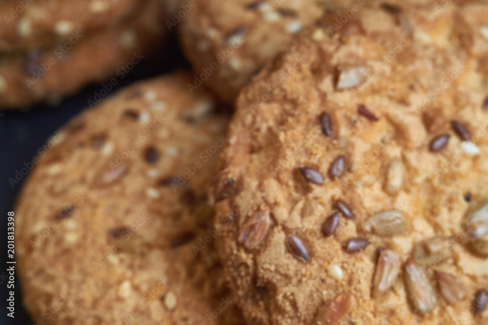 Fototapeta premium closeup oat large biscuits with sesame, flax and sunflower seeds. Macro