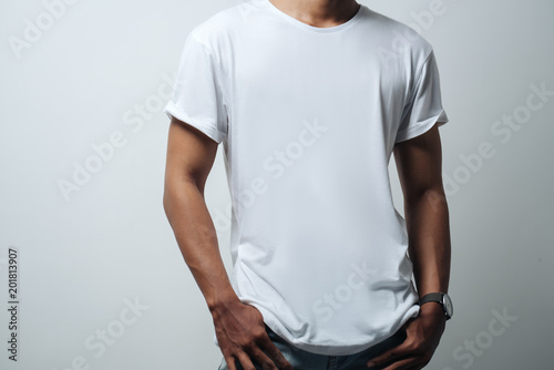 man in white blank t-shirt, empty wall, studio  casual style