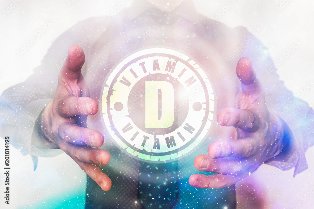 Fototapeta premium Man is showing vitamin D symbol between his hands