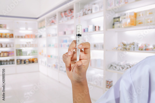 Hands the doctors filling a syringe on store medicine and pharmacy drugstore for background