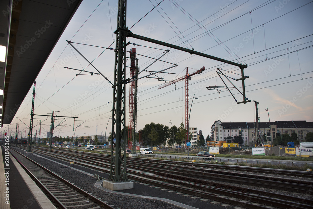 Empty railroad tracks of Mannheim Hauptbahnhof railway station with traffic road in morning