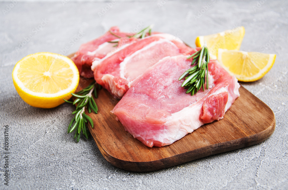 Fresh raw pork chops with spices and herbs Fresh raw pork chops with spices and herbs