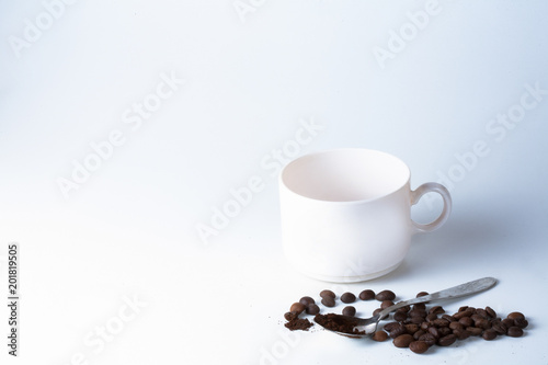 Coffee cup and beans on old kitchen table.