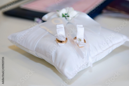 Wedding gold rings on the pillow close. The symbol of the marriage of the bride and groom.
