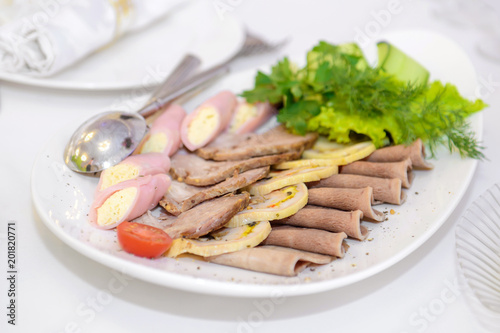 Cutting meat snacks. Cold dish with ham on the restaurant table. 