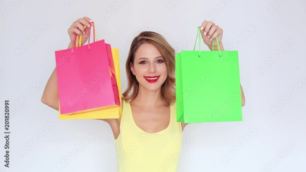 Young redhead girl with shopping bags on white background Young redhead girl with shopping bags on white background