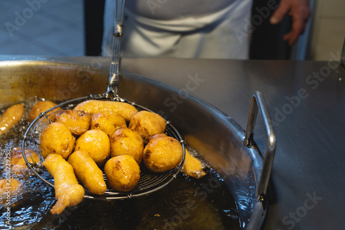 Freshly cooked Sicilian crispelle. Street food typical of Sicily, prepared with flour, ricotta, anchovies and fried. photo