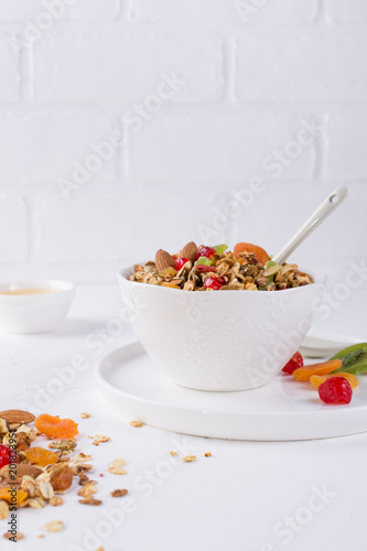 Bowl with homemade granola on white background for healthy breakfast . Healthy snak.