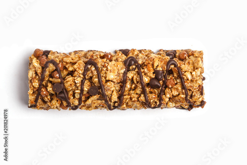 Chocolate granola bar isolated on white background. Healthy sweet dessert snack. Cereal granola bar with nuts, chocolate  and berries on a white background. Top view copy space.