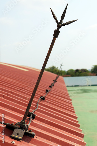 lightning rod or lightning conductor (Copper pole) on the roof of building for protection high voltage from thunder. 