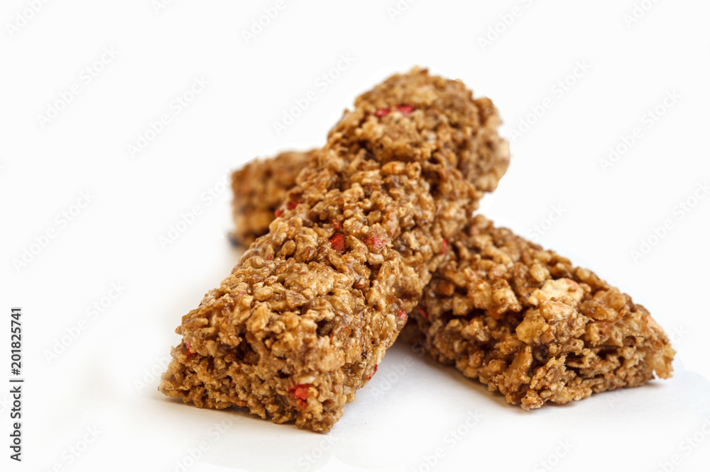 Strawberry granola bars isolated on white background. Healthy sweet dessert snack. Cereal granola bar with nuts and berries Strawberry granola bars isolated on white background. Healthy sweet dessert snack. Cereal granola bar with nuts and berries