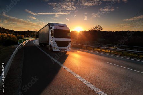 Truck transportation on the road at sunset 