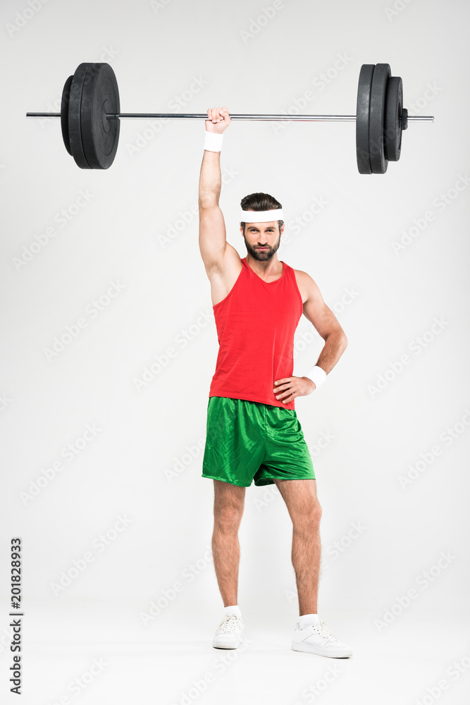 strong sportsman in retro sportswear training with barbell, isolated on white strong sportsman in retro sportswear training with barbell, isolated on white