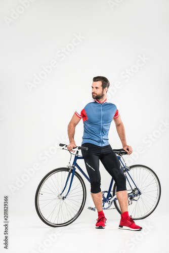handsome bearded sportsman with bicycle, isolated on white