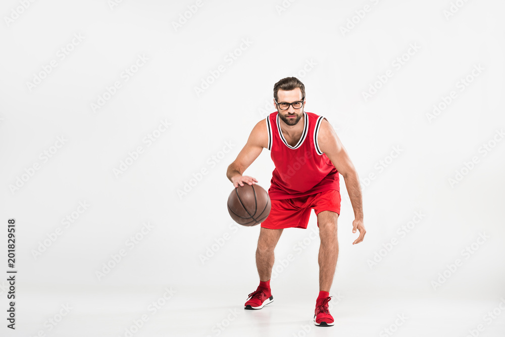 bearded sportsman in red sportswear and retro glasses playing basketball, isolated on white bearded sportsman in red sportswear and retro glasses playing basketball, isolated on white