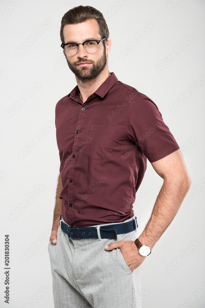 Fototapeta premium handsome bearded man posing in casual closing and eyeglasses, isolated on grey