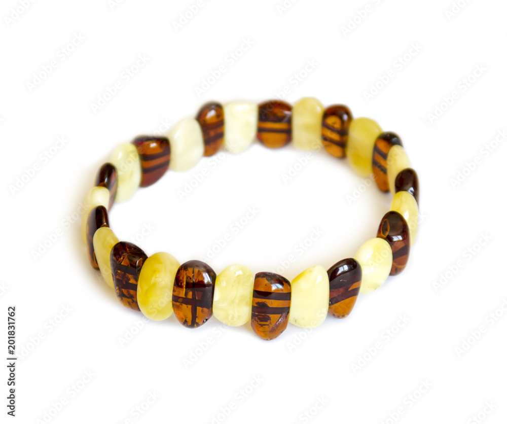 Female decoration, bracelet made of amber on a light background