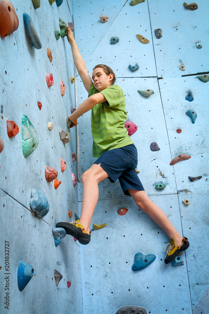 Teenage Boy Training On Climbing Wall Teenage Boy Training On Climbing Wall