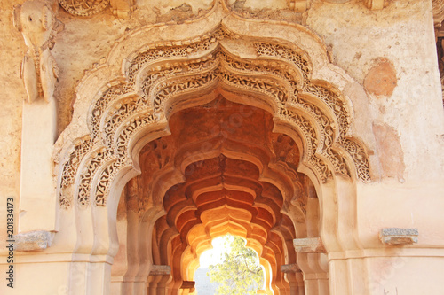 Lotus Mahal Temple in Hampi, Karnataka, India.Beautiful carved stone arch and sunset. A popular tourist route from the GOA state. Beautiful hindu temple