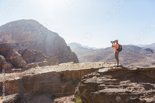 Tourist on rock in Petra. Jordan landscape