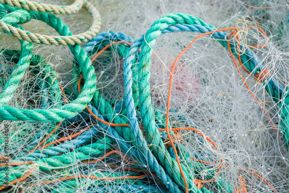 A tangled mess of fishing nets plastic rope and other debris washed up on a  coastal beach ideal for an ecological hazard or pollution concept Stock  Photo