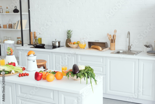 Fototapeta Naklejka Na Ścianę i Meble -  interior of white modern kitchen with fruits and vegetables on kitchen counter