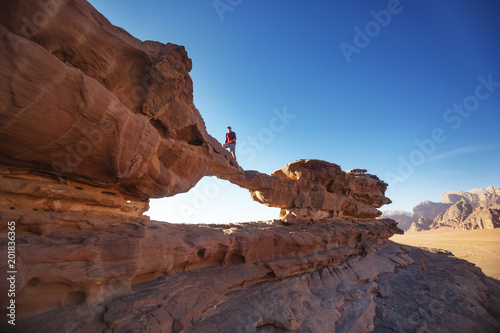 Tourist on rock. Wadi Ram desert. Stone bridge. Jordan landscape © Crazy nook