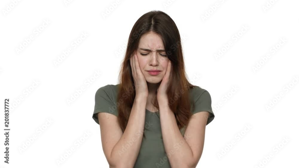 Portrait of caucasian female with dark hair worrying and screaming in fear closing mouth with hand, isolated over white wall. Concept of emotions Portrait of caucasian female with dark hair worrying and screaming in fear closing mouth with hand, isolated over white wall. Concept of emotions