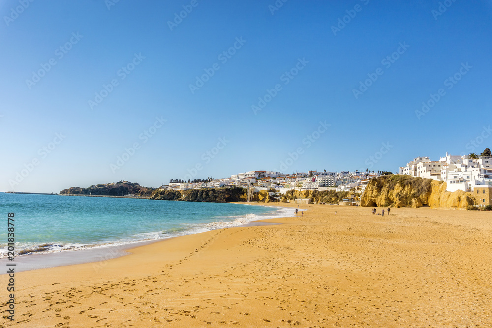 Wide, sandy beach in white city of Albufeira, Algarve, Portugal