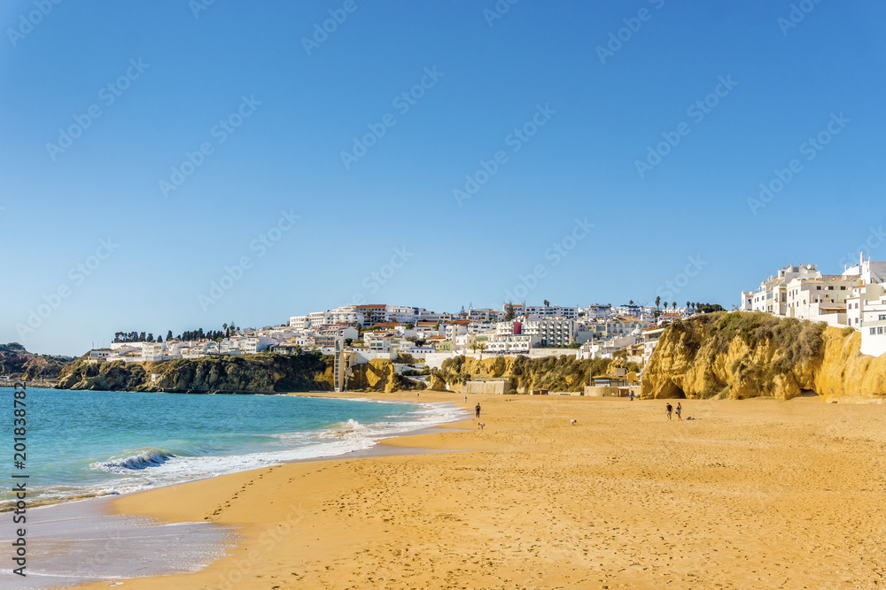 Wide, sandy beach in white city of Albufeira, Algarve, Portugal