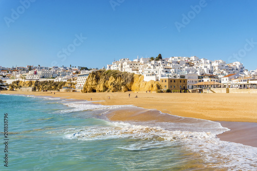 Wide, sandy beach in white city of Albufeira, Algarve, Portugal photo