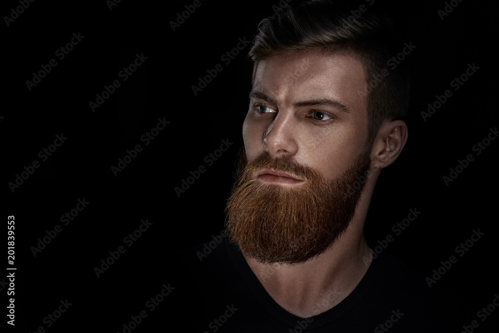 Studio shot of confidence attractive hipster Dramatic light concept Black background Copy space Bearded man